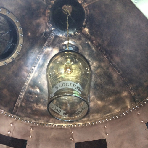 Vintage-style metal container with a glass inside, featuring the 'Badger' brand.