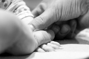 New born baby hand print in sand