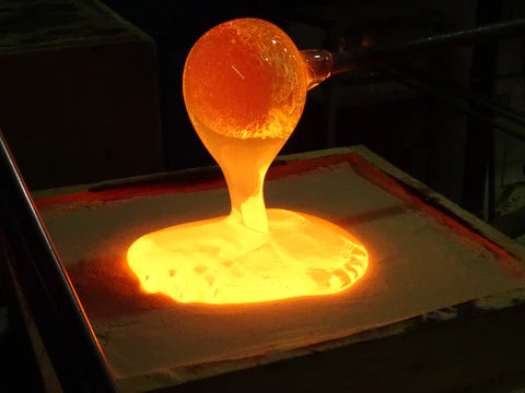 New born baby hand and foot print with molten glass being poured into the mould. 