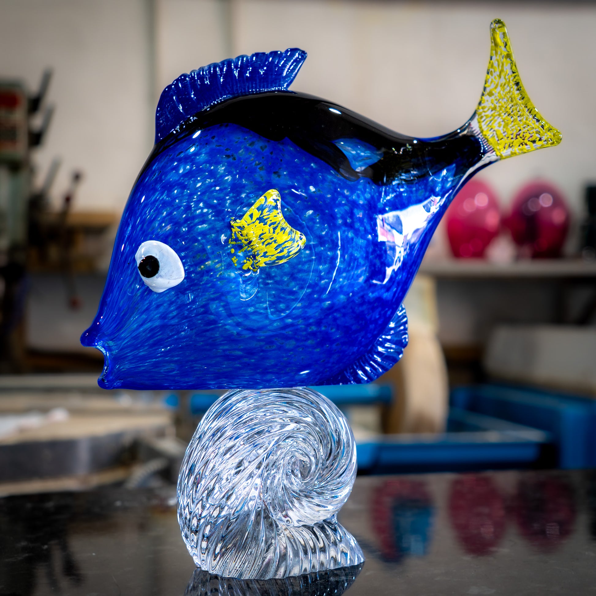 Hand-blown glass Dory surfing a wave